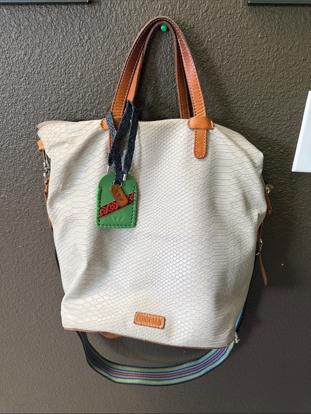 Consuela Thunderbird Cream Tote with Brown Leather Handles and Green Tag